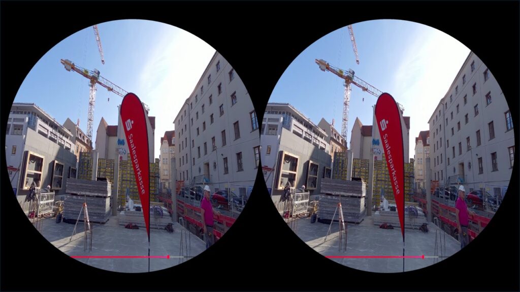 Stereoscopic view of a construction site with a crane, buildings, and a red vertical banner; a worker in pink stands near materials; black background framing two circular lenses.